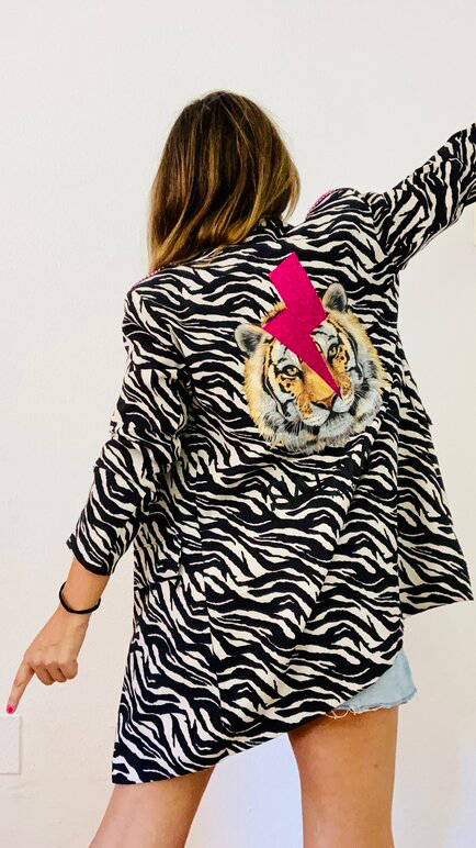 Mujer con blazer customizada de estampado de zebra.